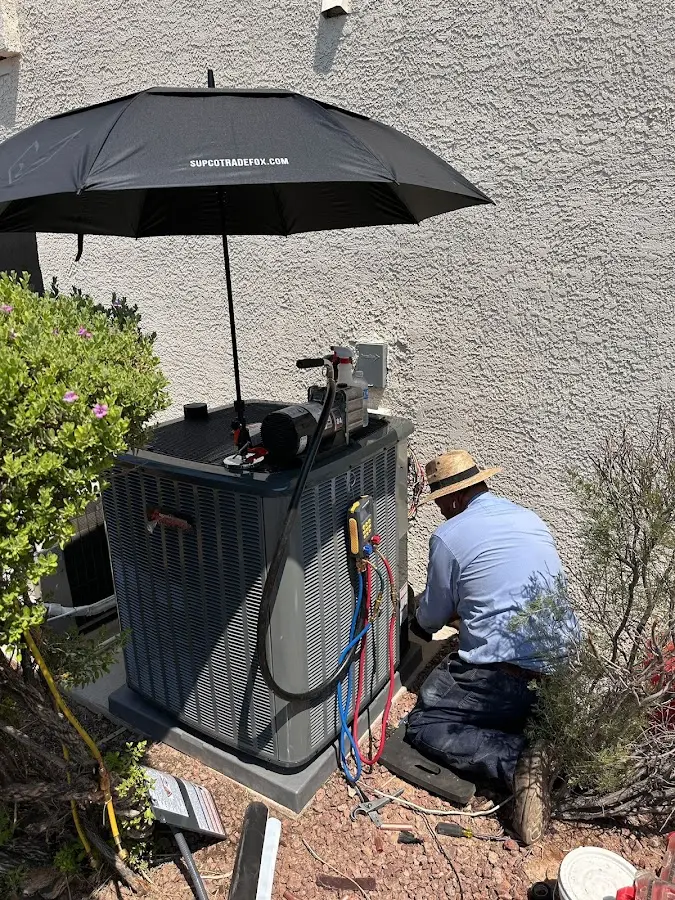 HVAC technician performing outdoor AC maintenance in Wyoming